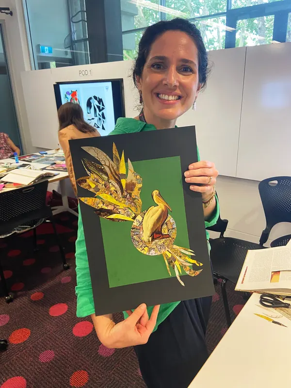 A Macquarie University staff member holding up her finished collage